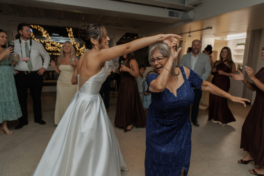 Bride dancing with wedding guests during the reception