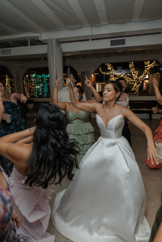 Wedding guests dancing and celebrating during AJ and Janel's reception