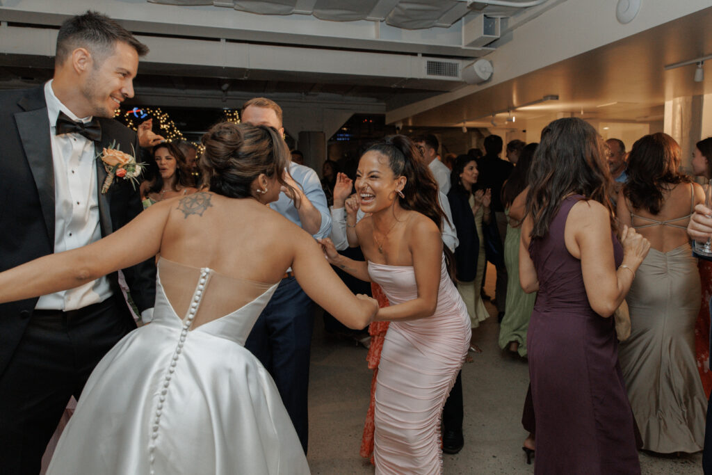 AJ and Janel celebrating with friends and family during their wedding reception
