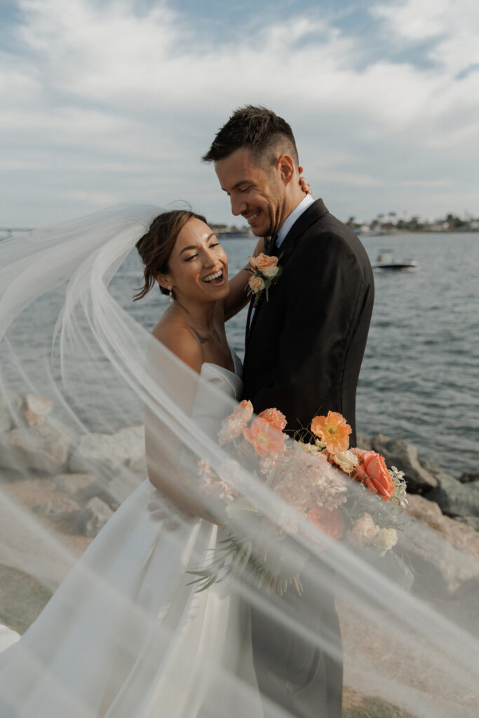 AJ and Janel during their waterfront wedding portraits at Malibu Farm San Diego