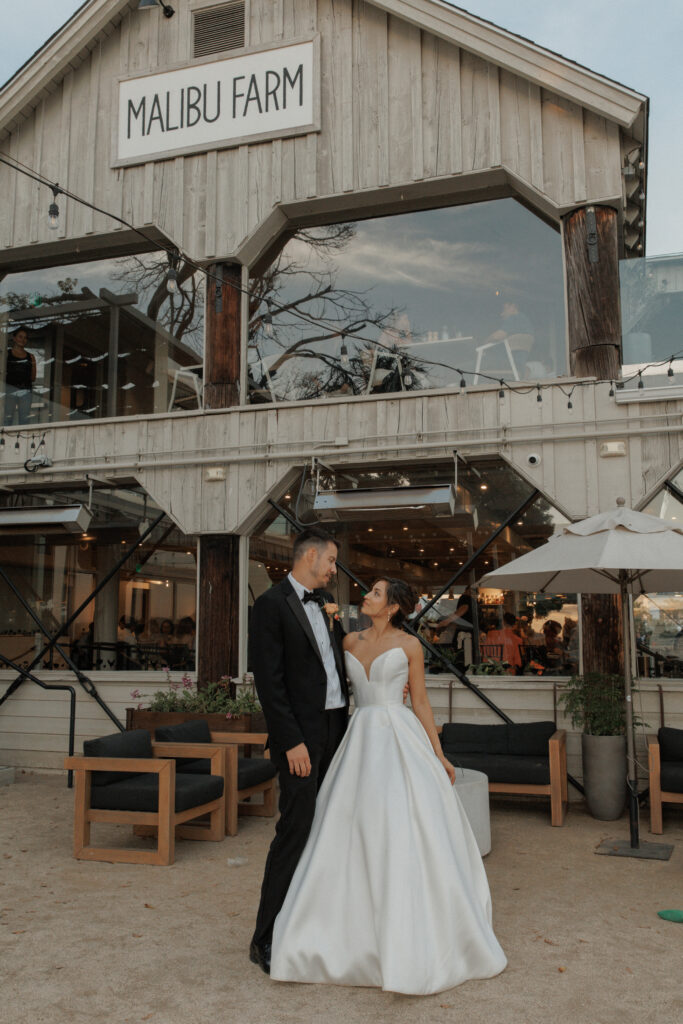 AJ and Janel outside Malibu Farm San Diego on their wedding day