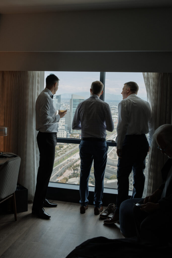 Groom and friends sharing a quiet moment before the wedding ceremony